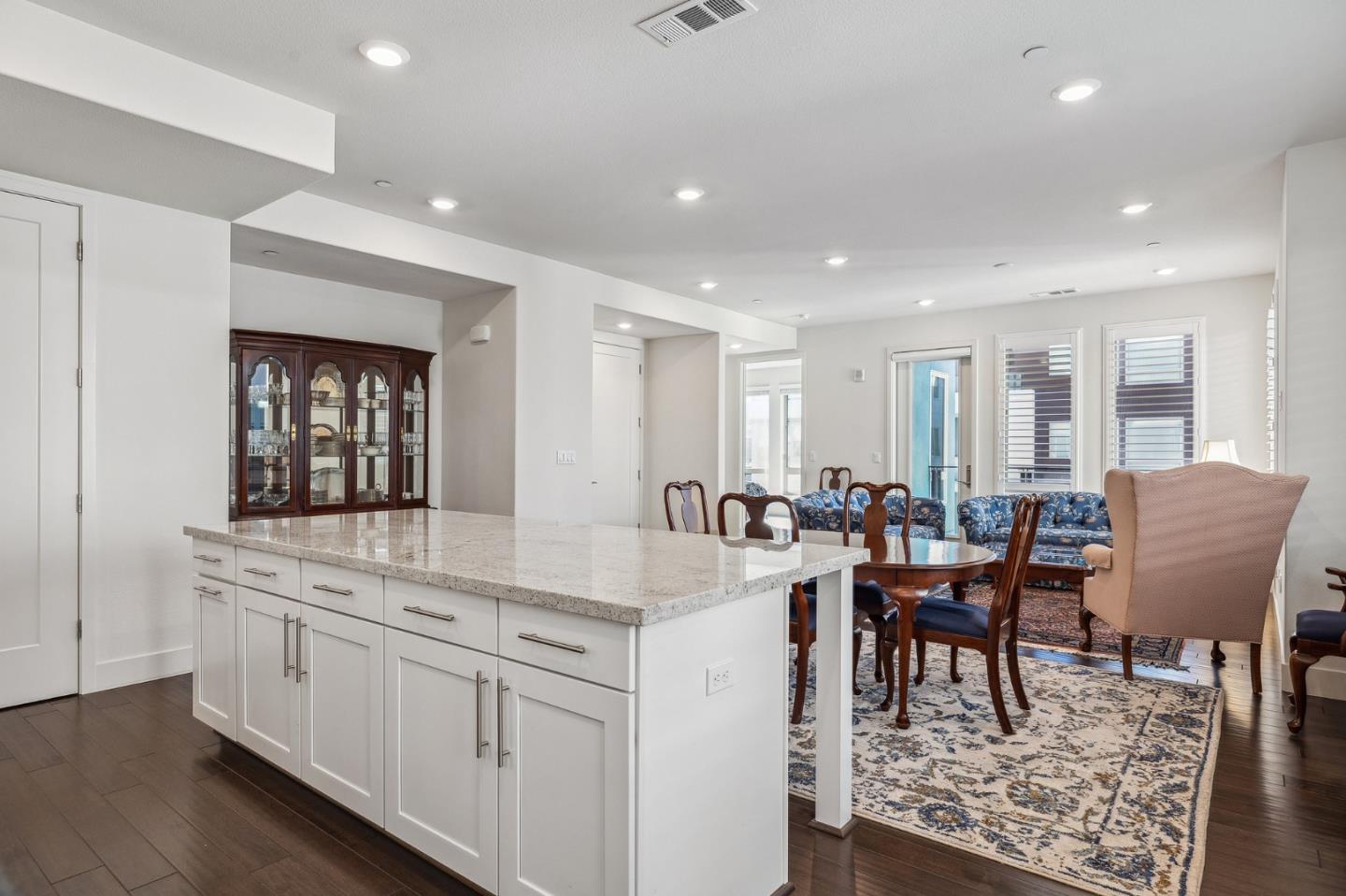 779 Eppleton Lane, Unit 304 Foster City, CA 94404 - Photo 13 of 34 a view of kitchen island dining space wooden floor dining table and chairs