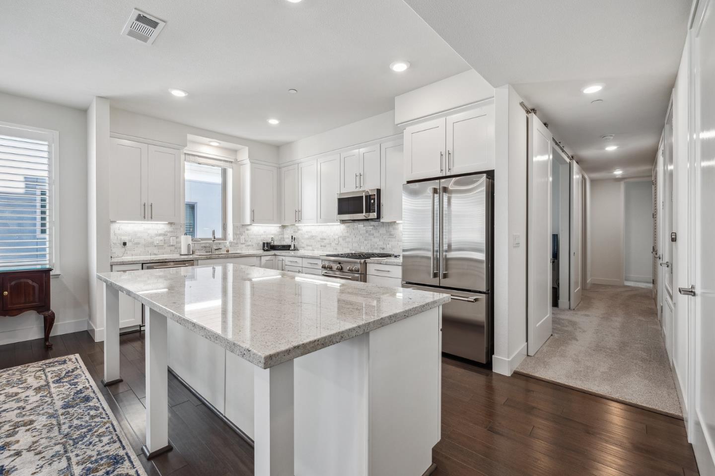 779 Eppleton Lane, Unit 304 Foster City, CA 94404 - Photo 14 of 34 a kitchen with stainless steel appliances granite countertop a sink stove and refrigerator