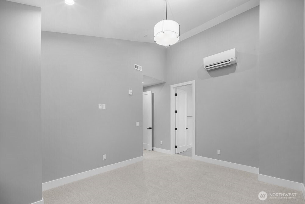 687 Northwest Locust Street Issaquah, WA 98027 - Photo 18 of 26 an empty room with a chandelier fan and a chandelier fan