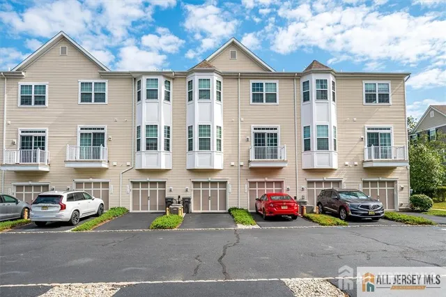 a view of a street that has couple of cars parked on the road