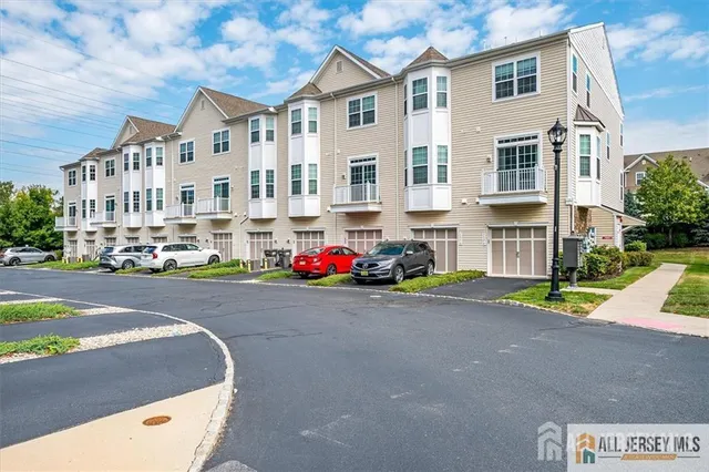 a front view of building with cars parked