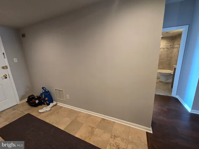 a room with wooden floor and shoes