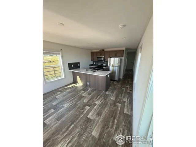 a kitchen with a refrigerator and a stove