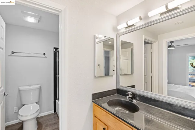 a bathroom with a sink a toilet and a mirror