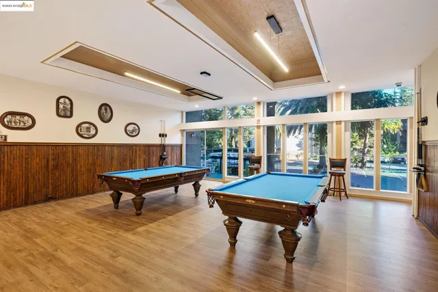 a kitchen with stainless steel appliances kitchen island granite countertop a table and chairs in it