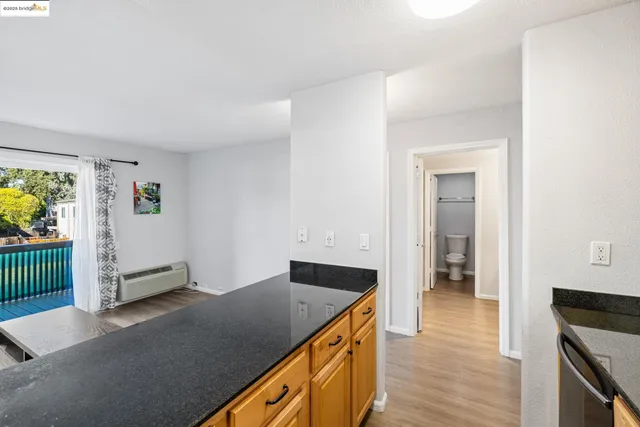 a view of kitchen with stainless steel appliances cabinets and wooden floor