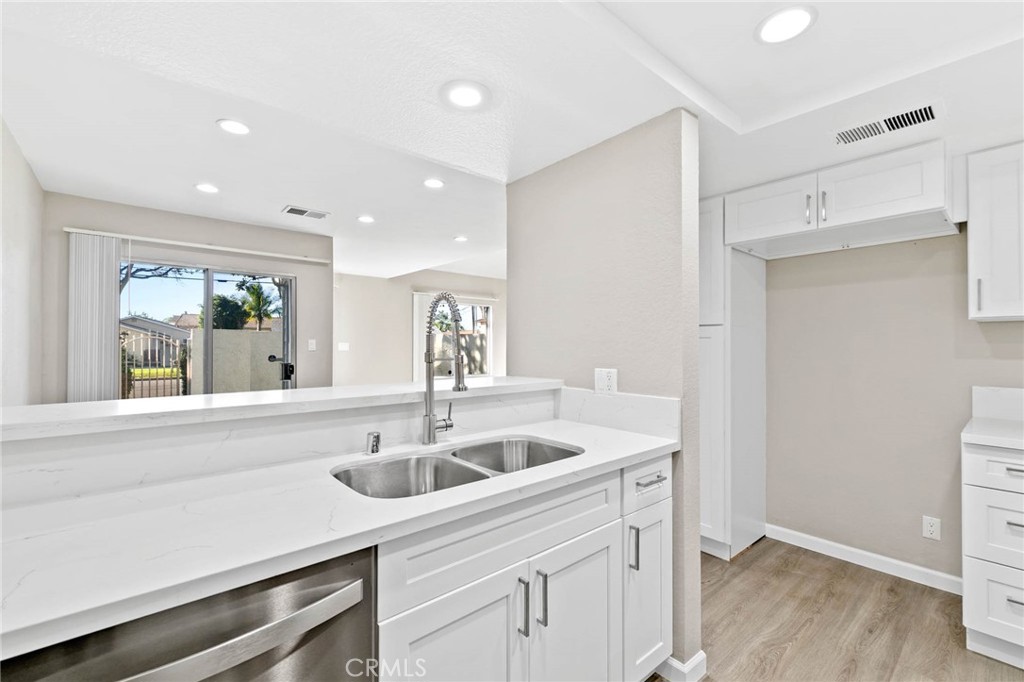 9013 Buckles Street Downey, CA 90241 - Photo 11 of 32 a kitchen with a sink and cabinets