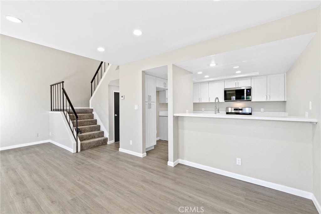 9013 Buckles Street Downey, CA 90241 - Photo 12 of 32 a view of kitchen with stainless steel appliances refrigerator stove microwave and cabinets