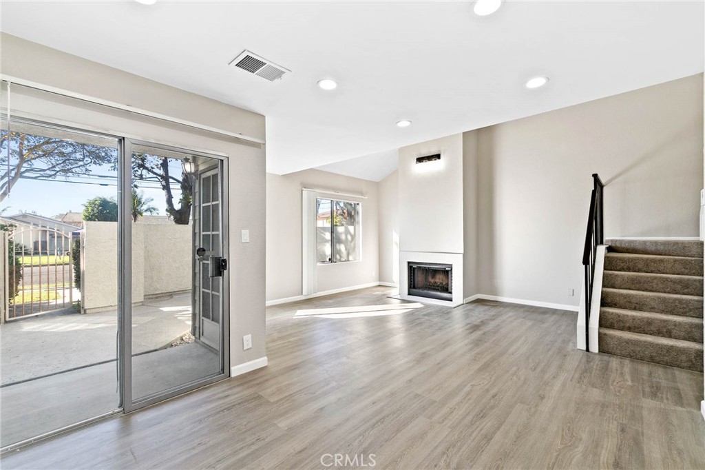 9013 Buckles Street Downey, CA 90241 - Photo 13 of 32 a view of a livingroom with wooden floor and a fireplace