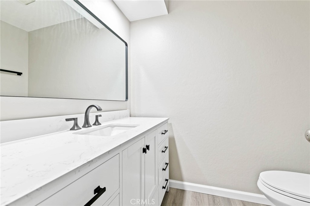 9013 Buckles Street Downey, CA 90241 - Photo 14 of 32 a bathroom with a sink and a toilet