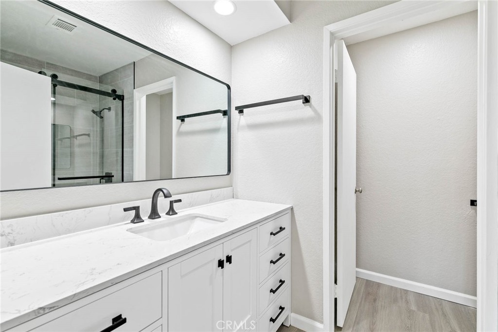 9013 Buckles Street Downey, CA 90241 - Photo 18 of 32 a bathroom with a sink and a mirror