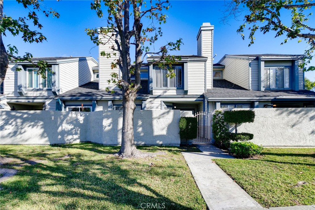 9013 Buckles Street Downey, CA 90241 - Photo 2 of 32 a front view of a house with a garden