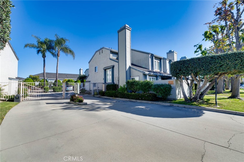 9013 Buckles Street Downey, CA 90241 - Photo 31 of 32 a row of palm trees and a yard in front of a house