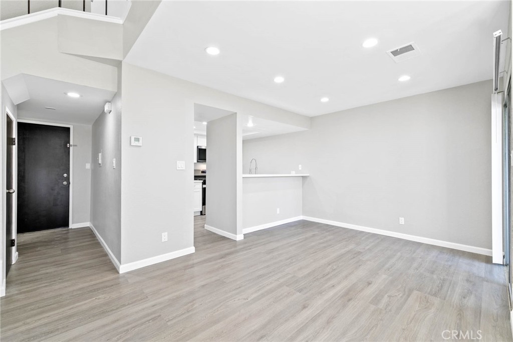9013 Buckles Street Downey, CA 90241 - Photo 8 of 32 a view of an empty room with wooden floor