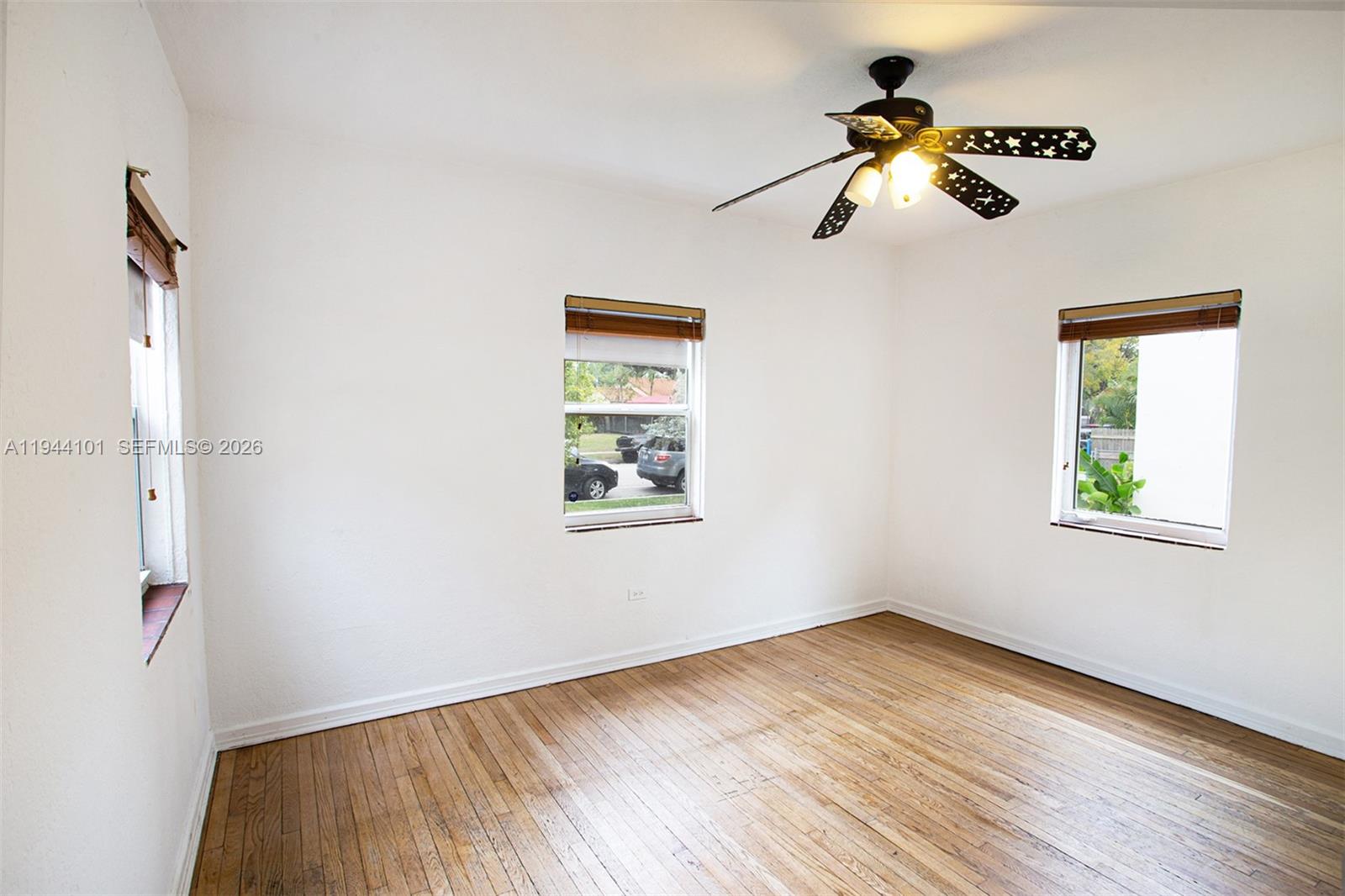 236 Southwest 28th Road Miami, FL 33129 - Photo 19 of 32 a view of empty room with wooden floor and fan