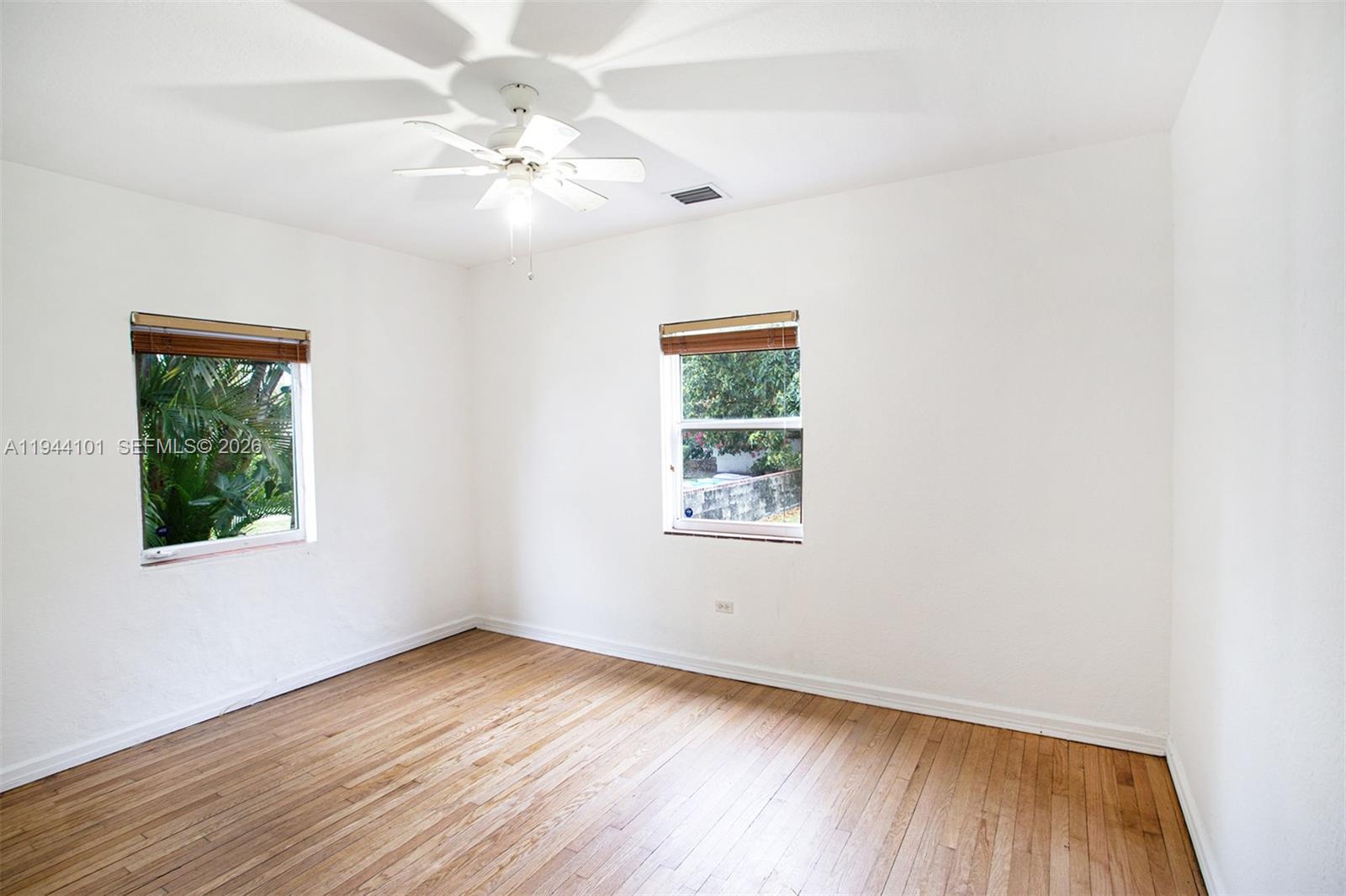 236 Southwest 28th Road Miami, FL 33129 - Photo 25 of 32 an empty room with a window and wooden floor