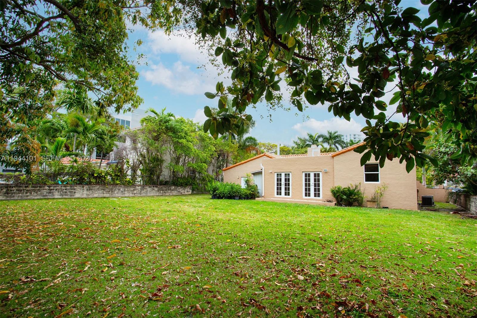 236 Southwest 28th Road Miami, FL 33129 - Photo 28 of 32 a view of a house with a big yard and large trees