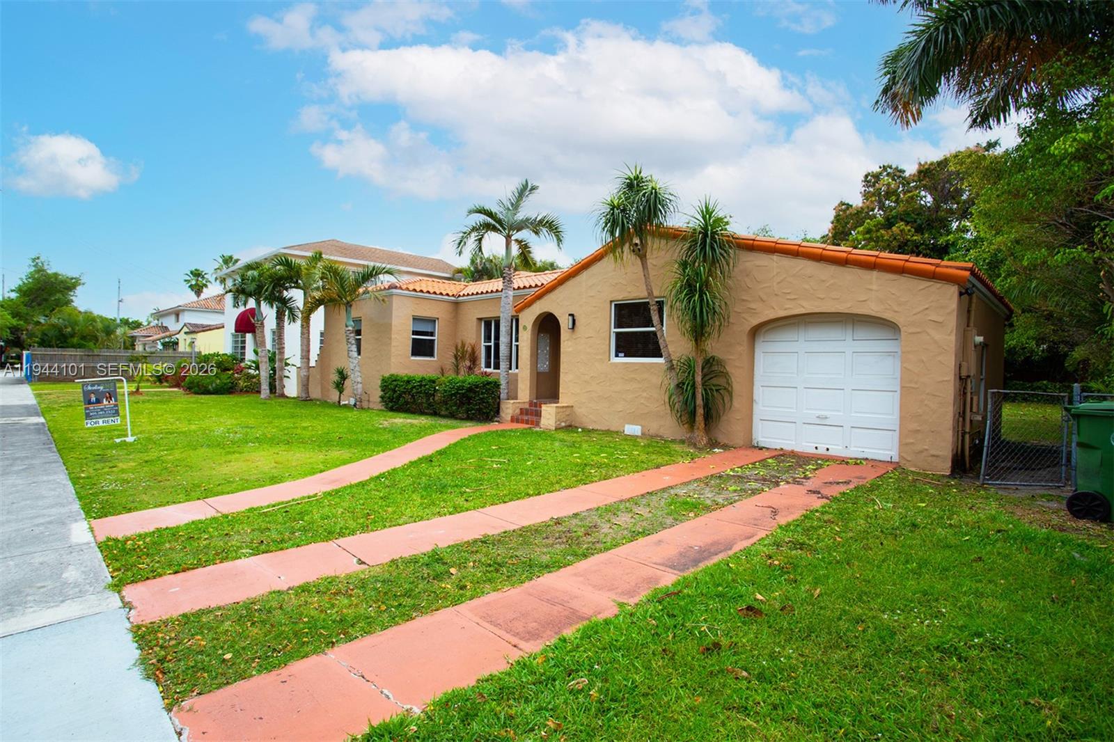 236 Southwest 28th Road Miami, FL 33129 - Photo 31 of 32 a front view of a house with a yard and garage