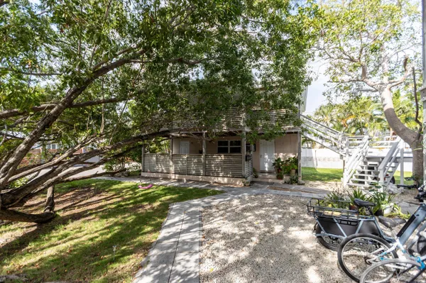 a backyard of a house with table and chairs