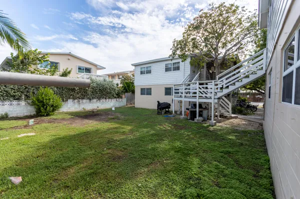 a view of house with yard and sitting area