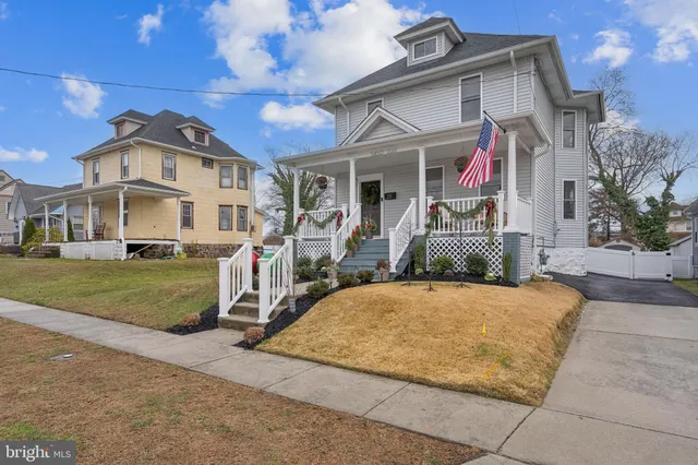 a view of a big house with a yard and plants