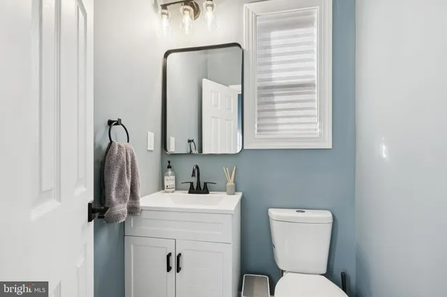 a bathroom with a toilet sink and mirror