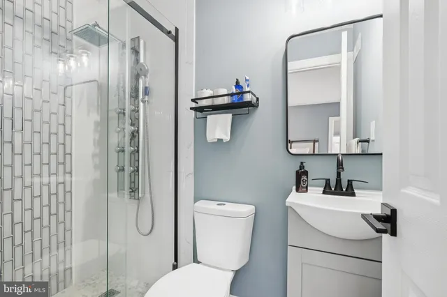 a bathroom with a toilet sink and shower