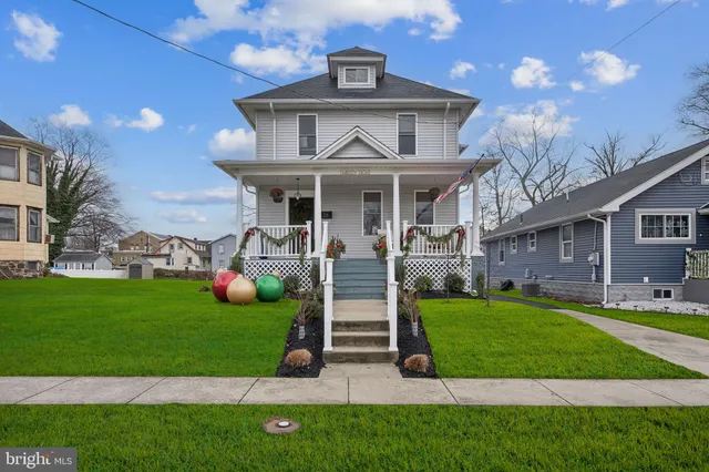 a front view of a house with a garden and plants