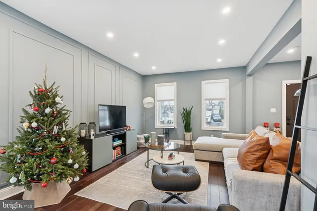 a living room with furniture potted plant and a flat screen tv