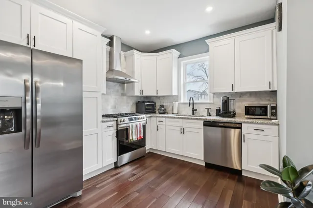 a kitchen with stainless steel appliances a refrigerator sink and cabinets