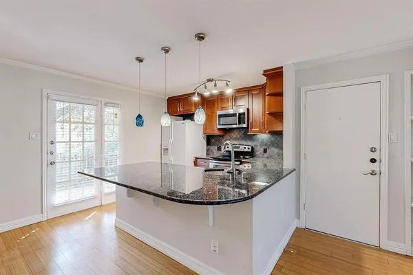 a kitchen with stainless steel appliances granite countertop a sink stove and microwave