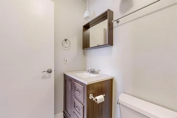 a bathroom with a toilet a sink and shower