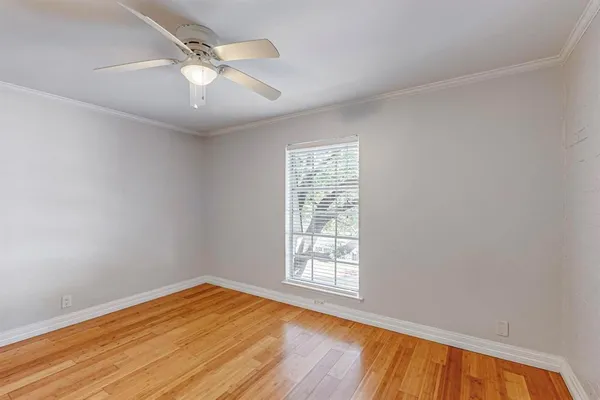 a view of a room with wooden floor and white walls