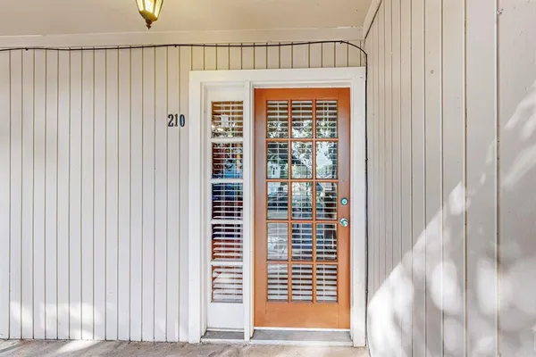 an empty room with windows and a fireplace