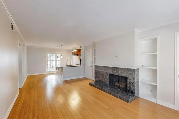 a kitchen with kitchen island a counter top a stove and cabinets