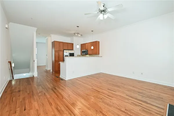 a view of livingroom with hardwood floor and ceiling fan