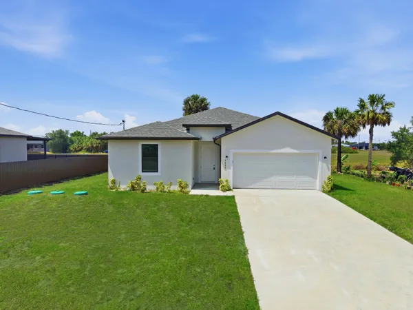 a front view of house with yard and green space