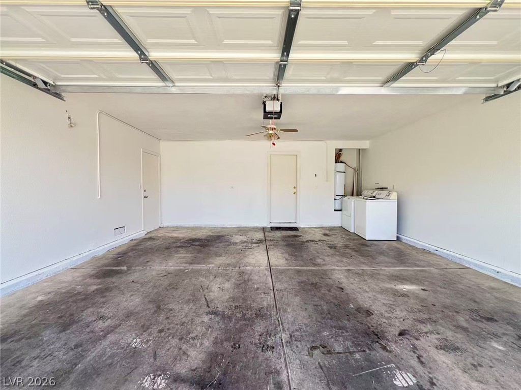 8284 West Rochelle Avenue Las Vegas, NV 89147 - Photo 28 of 29 A spacious garage features a dedicated laundry area and overhead door opener for convenience.