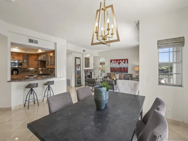 a view of a dining room with furniture and a chandelier
