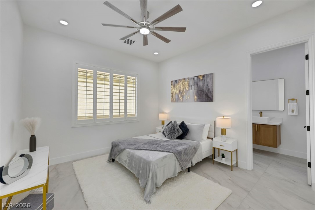 5015 Rivedro Street Las Vegas, NV 89135 - Photo 46 of 91 Well-lit sleeping quarters with a ceiling fan, tiled flooring, and a private entry to an adjacent washroom.