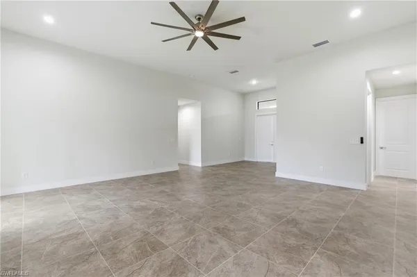 an empty room with fan and a ceiling fan