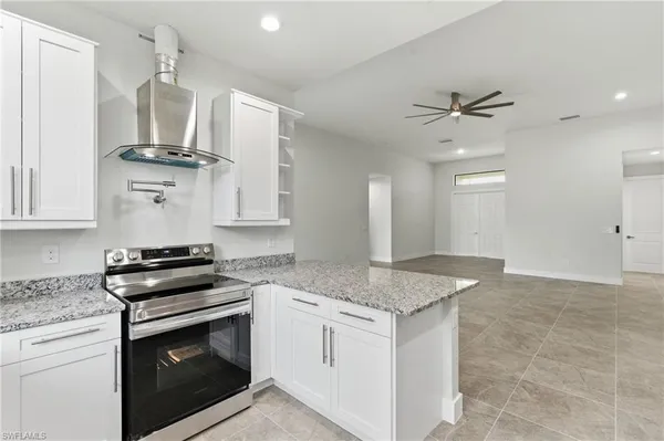 a kitchen with stainless steel appliances granite countertop a stove and a sink