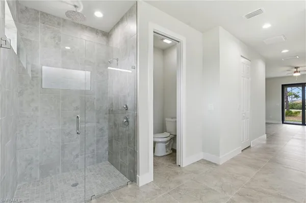 a bathroom with a shower and a glass door