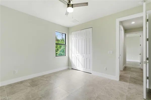 a bathroom with a granite countertop toilet a sink and mirror