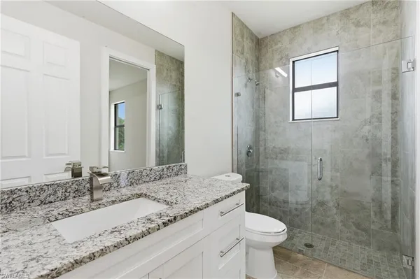 a bathroom with a toilet sink and a mirror