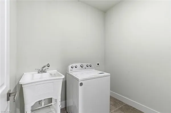 a view of an empty room with window and closet