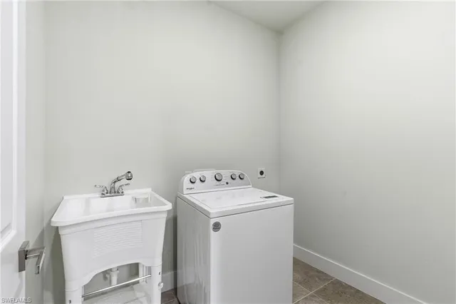 a view of an empty room with window and closet