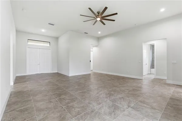 an empty room with fan and a ceiling fan