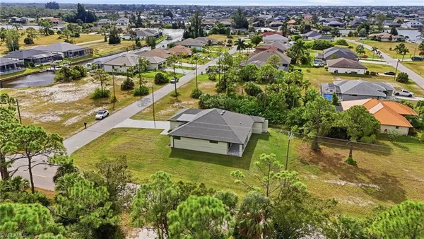 an aerial view of a house with a yard