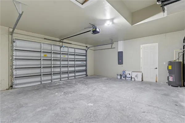 a view of empty room with stairs and washing machine